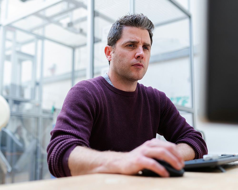 Man pondering at computer